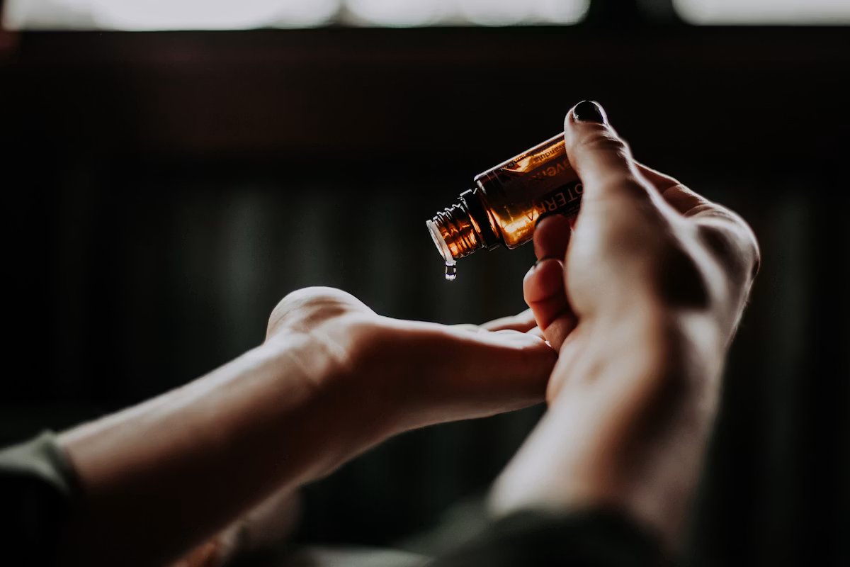 Essential oil being dispensed into an open palm
