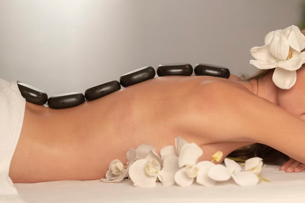 Hot stone ritual with orchid blossoms